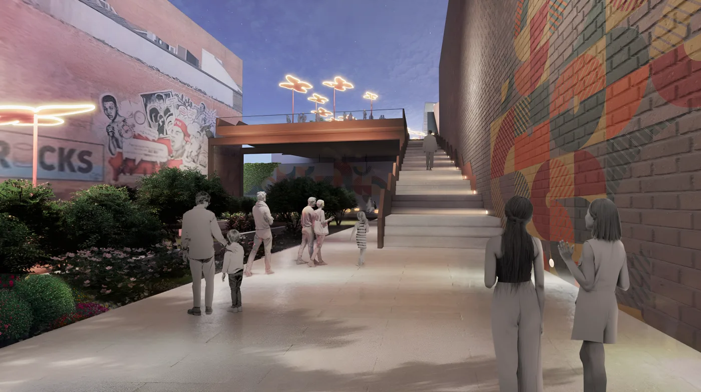 People walk a planted path between a brick wall with a boxing mural and steps rising toward the Center